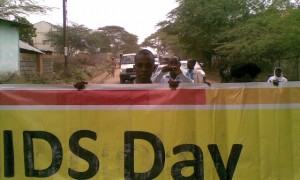 In the streets of Garissa with a banner to the procession (Pambazuka News).